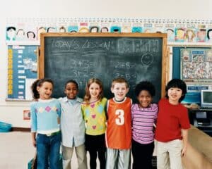 Kids in front of chalkboard